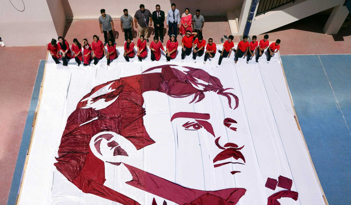 Students and teachers in Qatar piece together massive cloth portrait of Amir